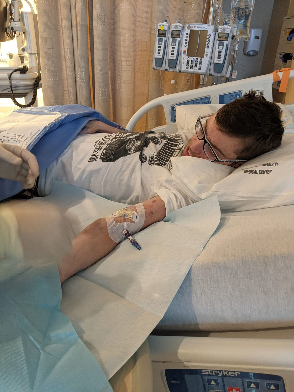 PuzzlePup founder Mike O'Brien during a hospital stay before Normie became his service dog